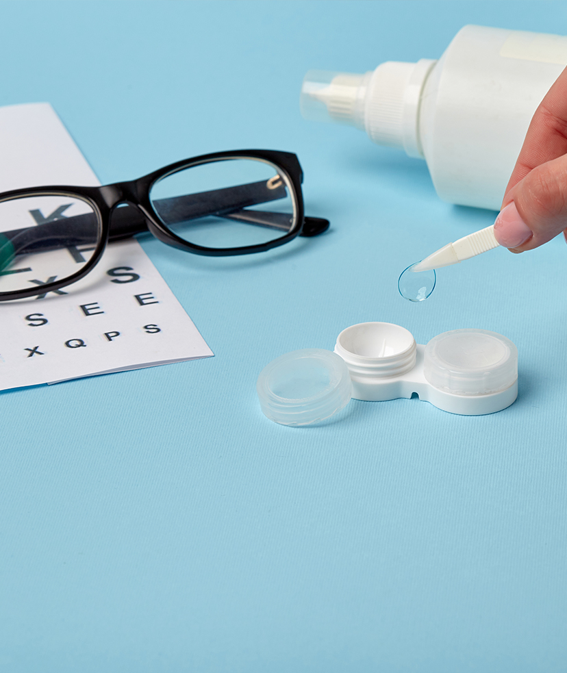 Photo of a contact lens, a contact case, solution, and eye glasses