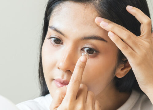 Photo of a woman putting in hard to fit contacts