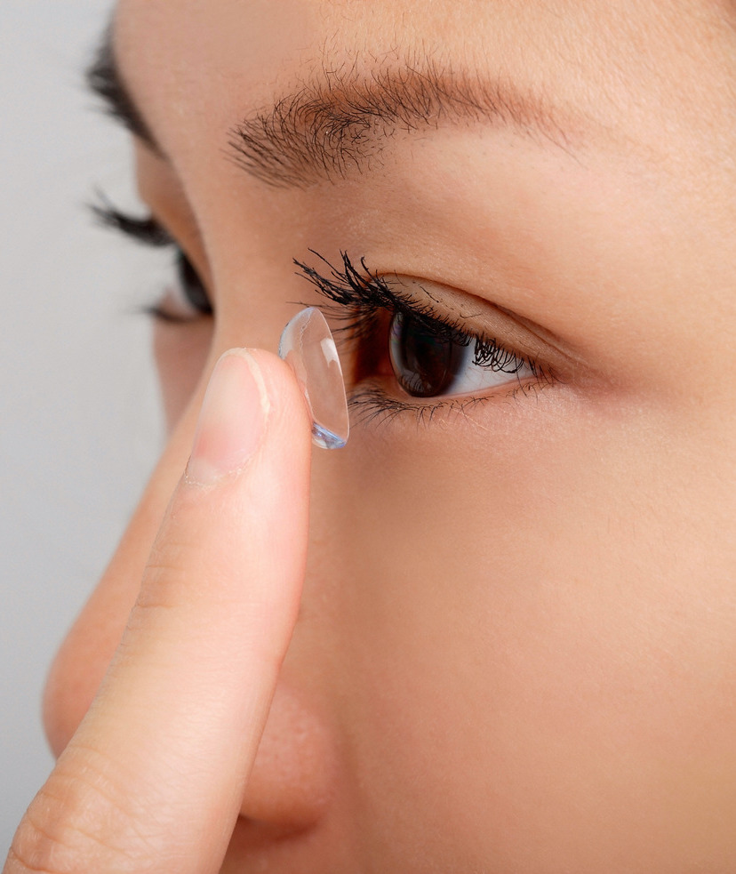 Photo of a woman putting in a contact lens