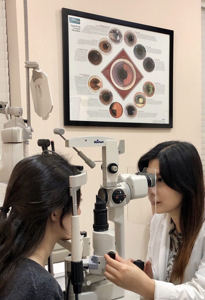 Photo of Dr. Chen giving a patient a medical eye exam