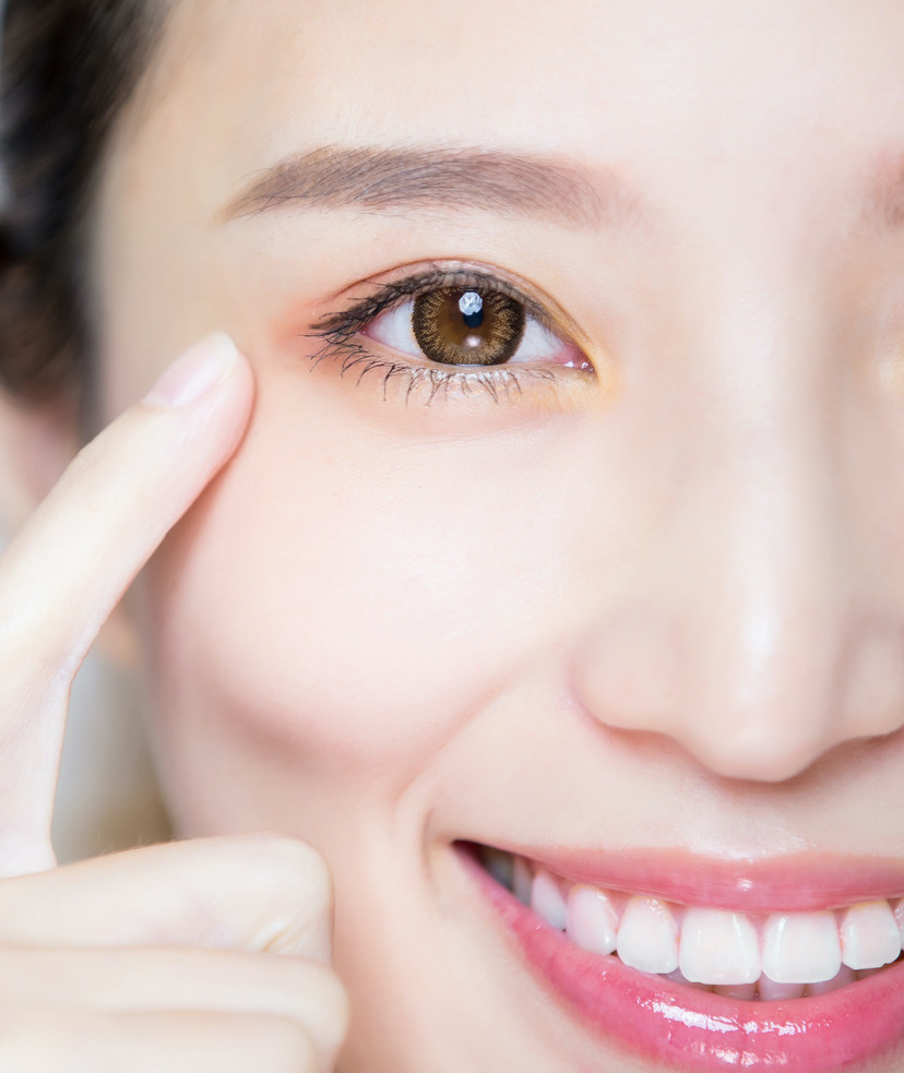 Photo of a woman putting her finger close to her eye