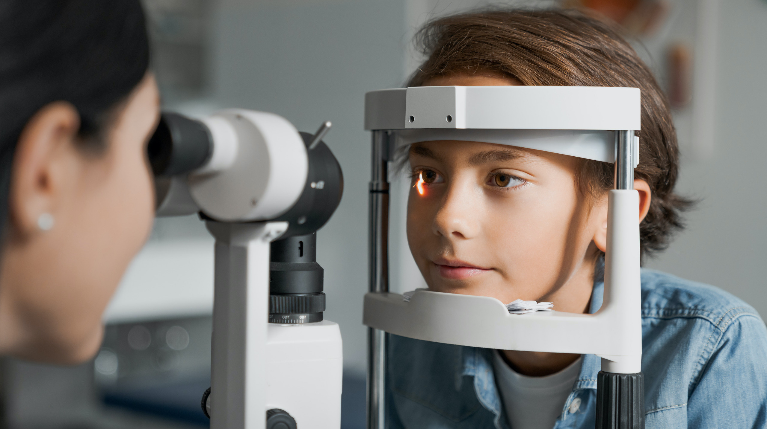 Photo of a young boy getting an eye exam